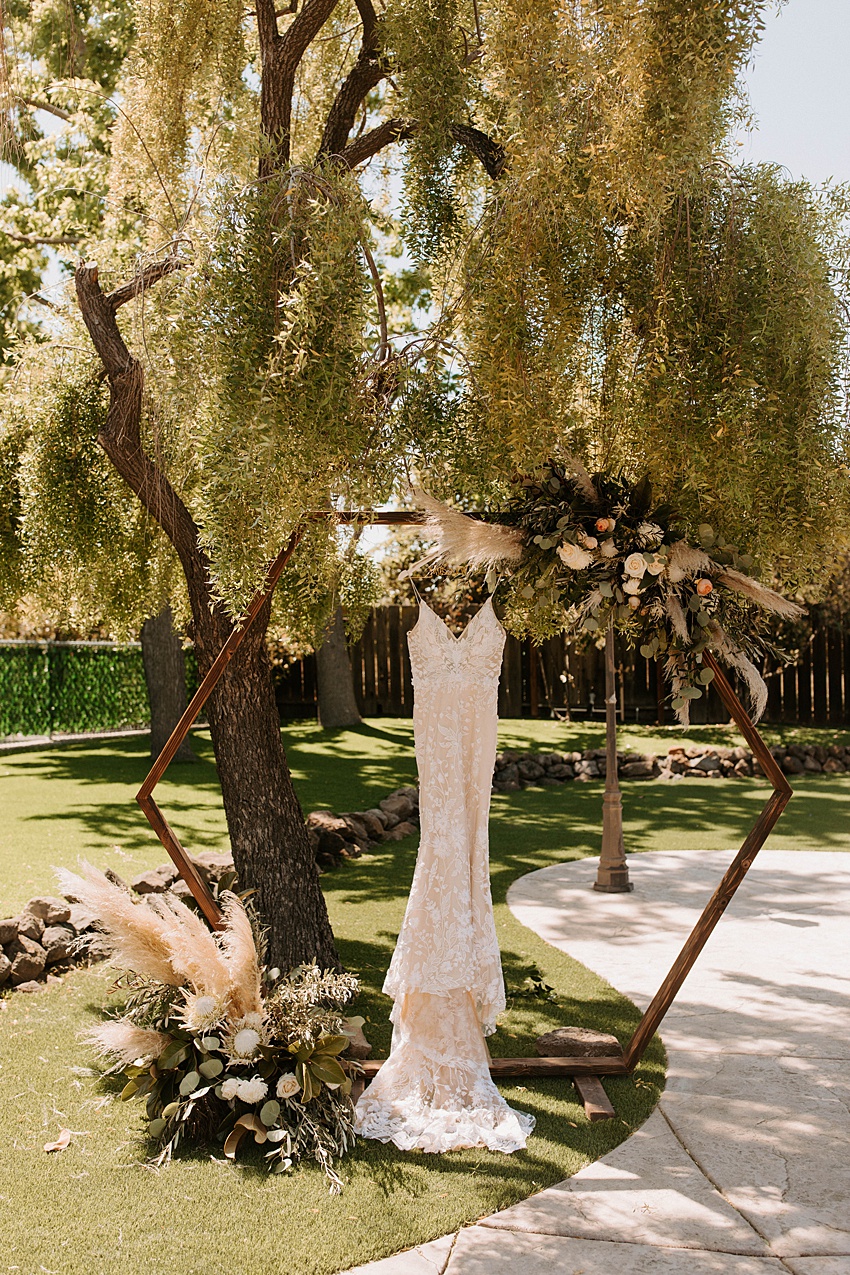 Oakley, CA Backyard Modern Boho Wedding - dress hanging at alter