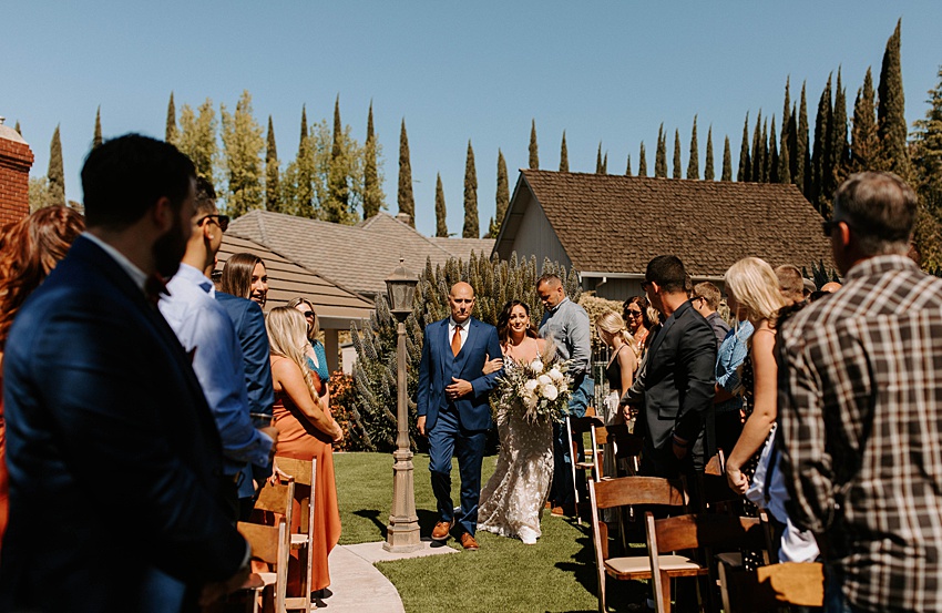 Oakley, CA Backyard Modern Boho Wedding - bride walking down aisle