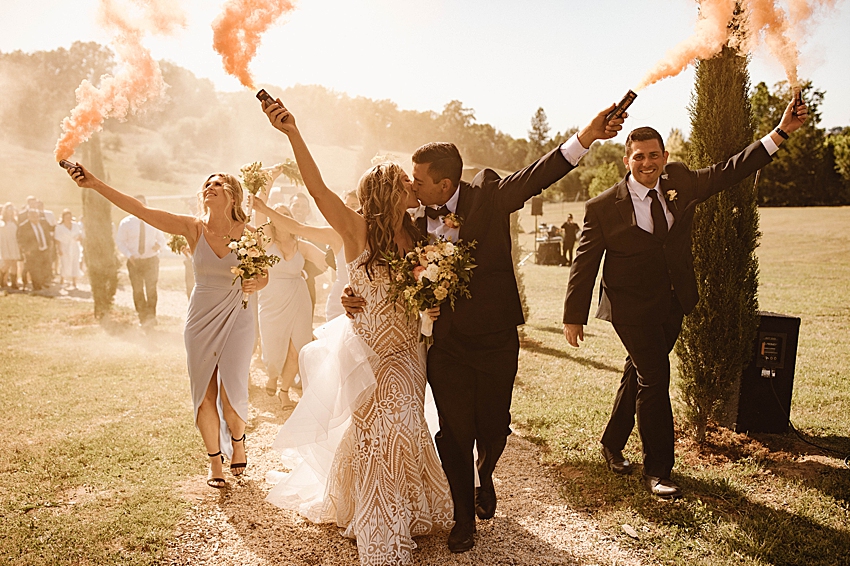 outdoor boho chic minimalist wedding ceremony with smoke bombs